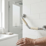 Bathroom grab bar with textured handle in a tiled bathroom setting