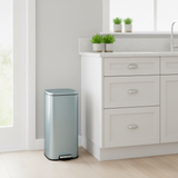 Dustbin against kitchen wall
